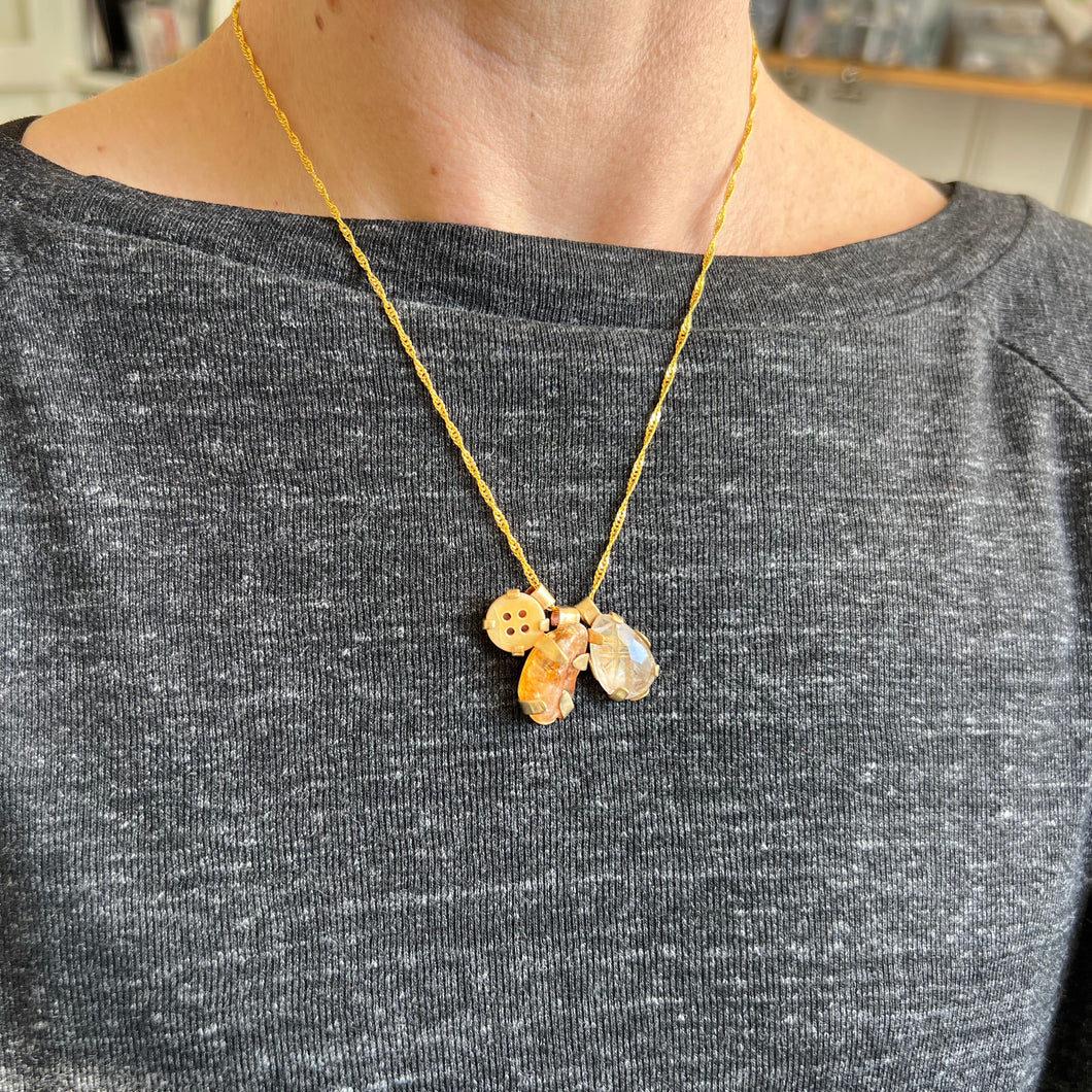 Touchstone Pendant Necklace: 18k gold plated chain with golden rutilated quartz, citrine stone and heritage button pendants