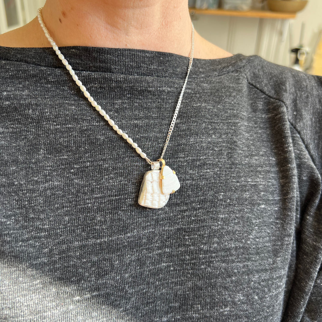 Touchstone Pendant Necklace: Pearl and silver plated chain with white shell pendants